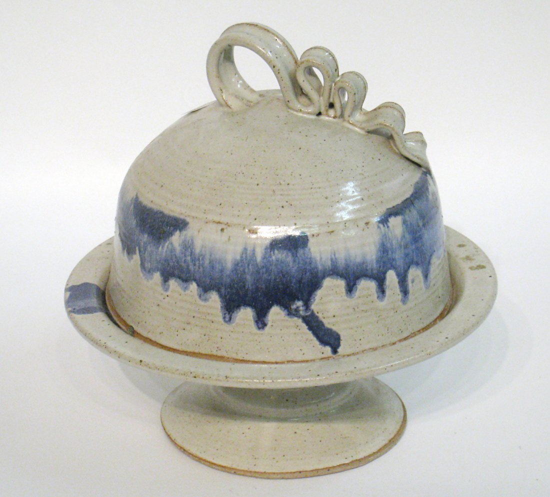 Ceramic Cake Stand And Cover: Hand thrown and glazed with applied ribbon handle. about 15". Shipping: We are able to pack and ship this item to an address in the United States for $55.00 via USPS Priority Mail or via FedEx Ground/