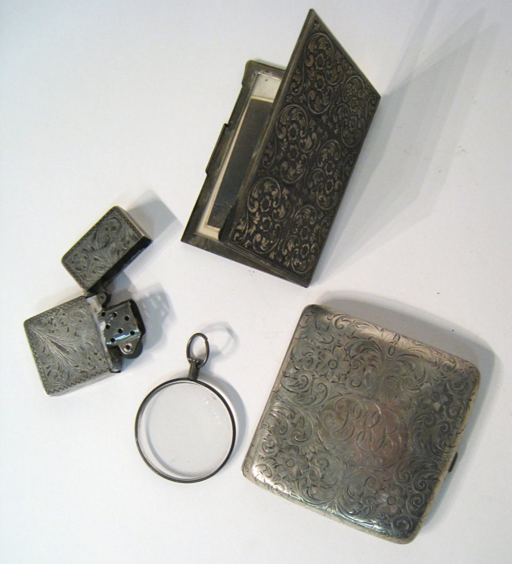 Silver Items: Includes a "Zippo" like lighter, picture frame, cigarette box and monocle. Shipping: We are able to pack and ship this item to an address in the United States for $25.00 via USPS Priority Mail. Tracki