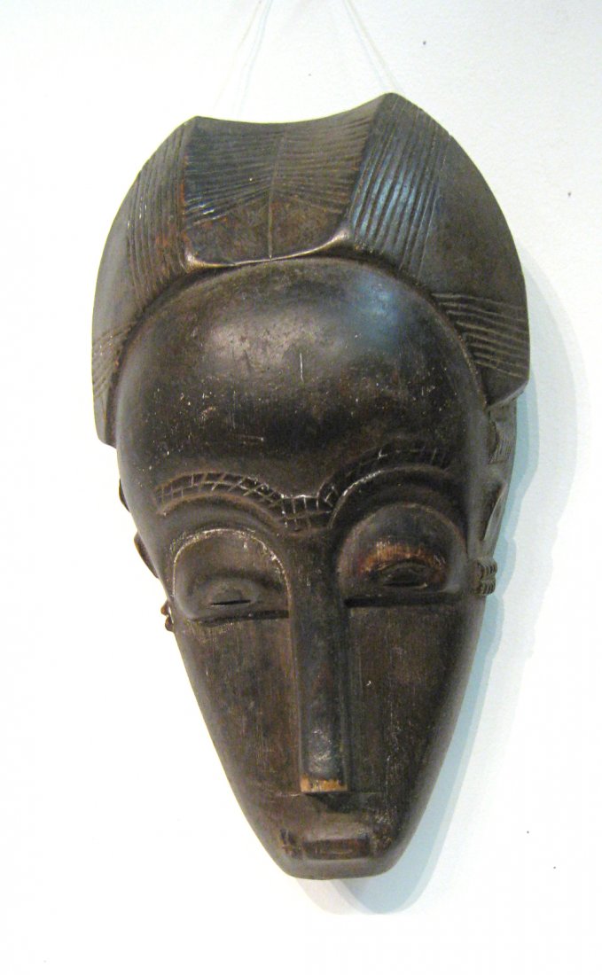 Antique Carved Wood African Mask: Twelve inches in height in good condition. Shipping: We are able to pack and ship this item to an address in the United States for $50.00 via USPS Priority Mail or via FedEx Ground/Home Delivery. Trac