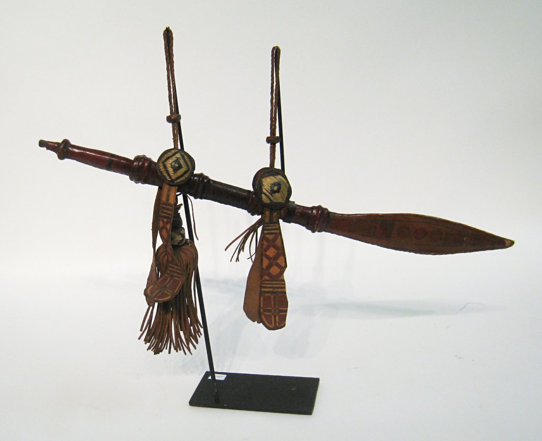 African Knife And Sheath: Possibly of Senegalian origin, a small country in West Africa, a 19th century knife or saber, 25" in Length. The painted leather and woven medallions , with leather strips form the sheath and attachme