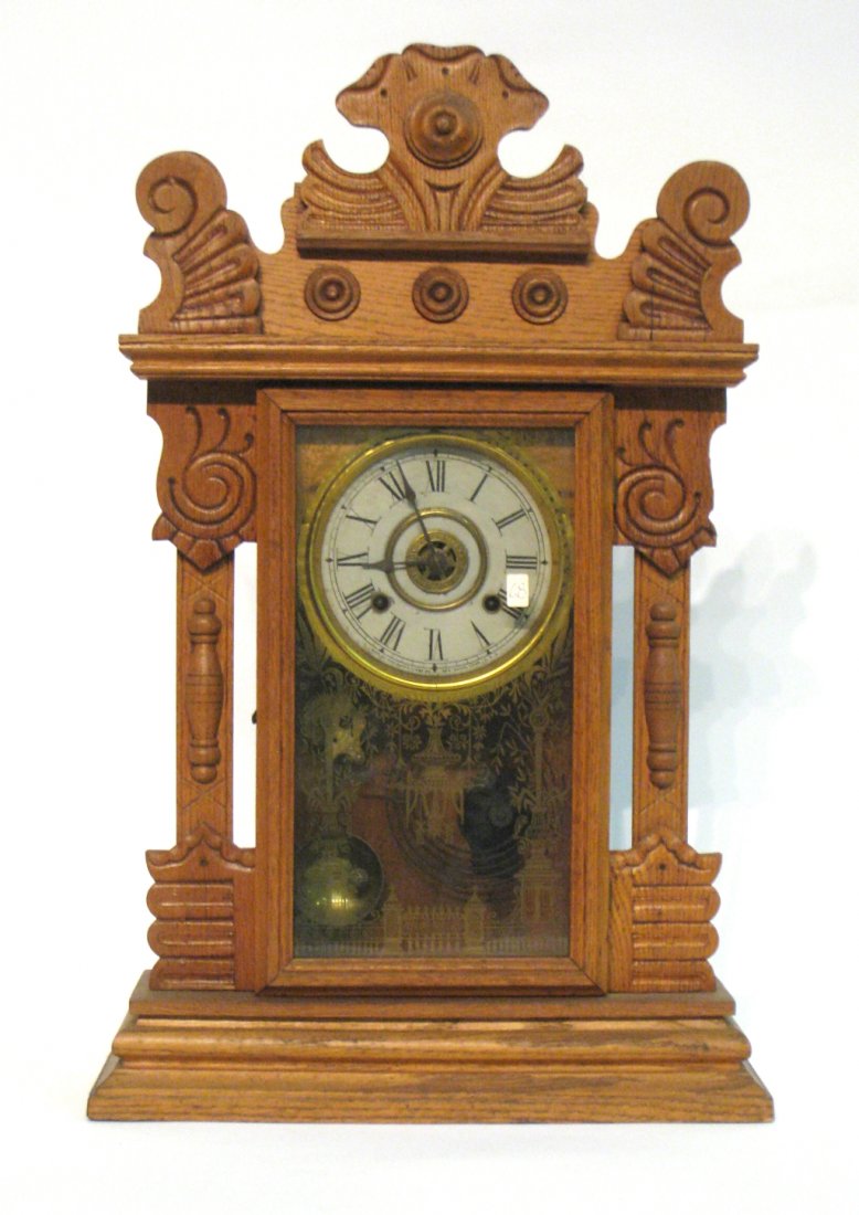 Oak 19th C. American Shelf Clock: Manufactured by the New Haven clock Company. Shipping: We are able to pack and ship this item to an address in the eastern states for $50.00 or to the western states for $80.00 via USPS Priority Mail 
