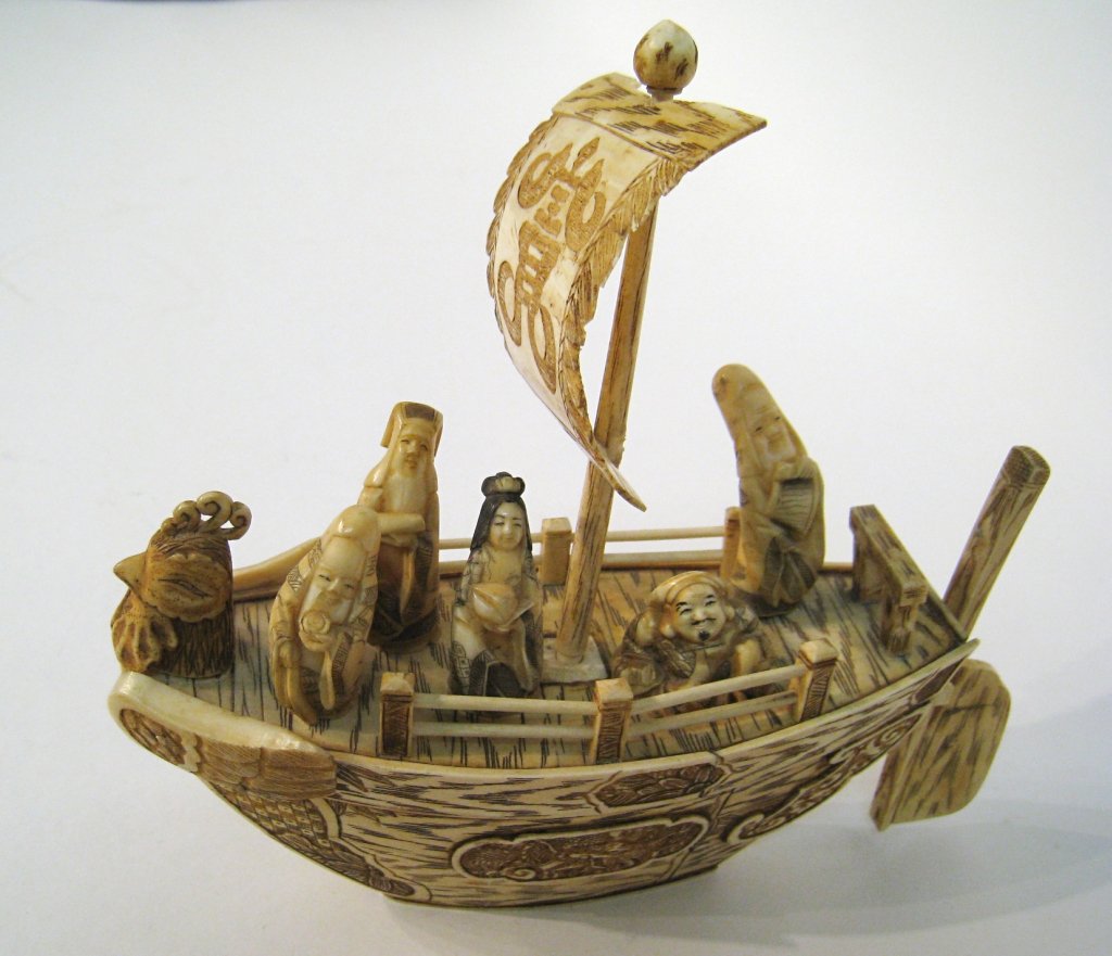 Ivory Carved Sailing Ship: A carved and highly detailed etched engraved or scrimshawed sailing ship with six Netsuke size wise man figures occupying the deck. Possibly Japanese, 19th century. Shipping: We are able to pack and s