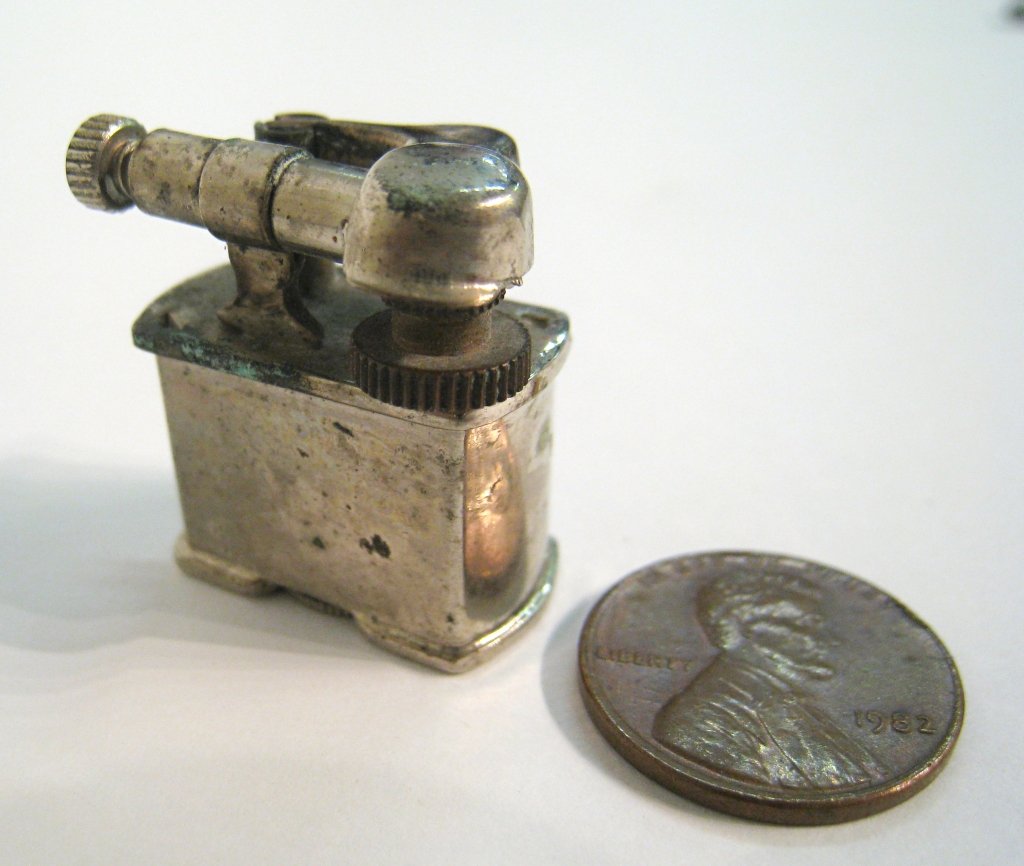 Golden Wheel Cigarette Lighter: "Worlds smallest lighter!" About 1" tall. This may work, although there seems to be no flint and of course our of fluid. Shipping: We are able to pack and ship this item to an address in the United St