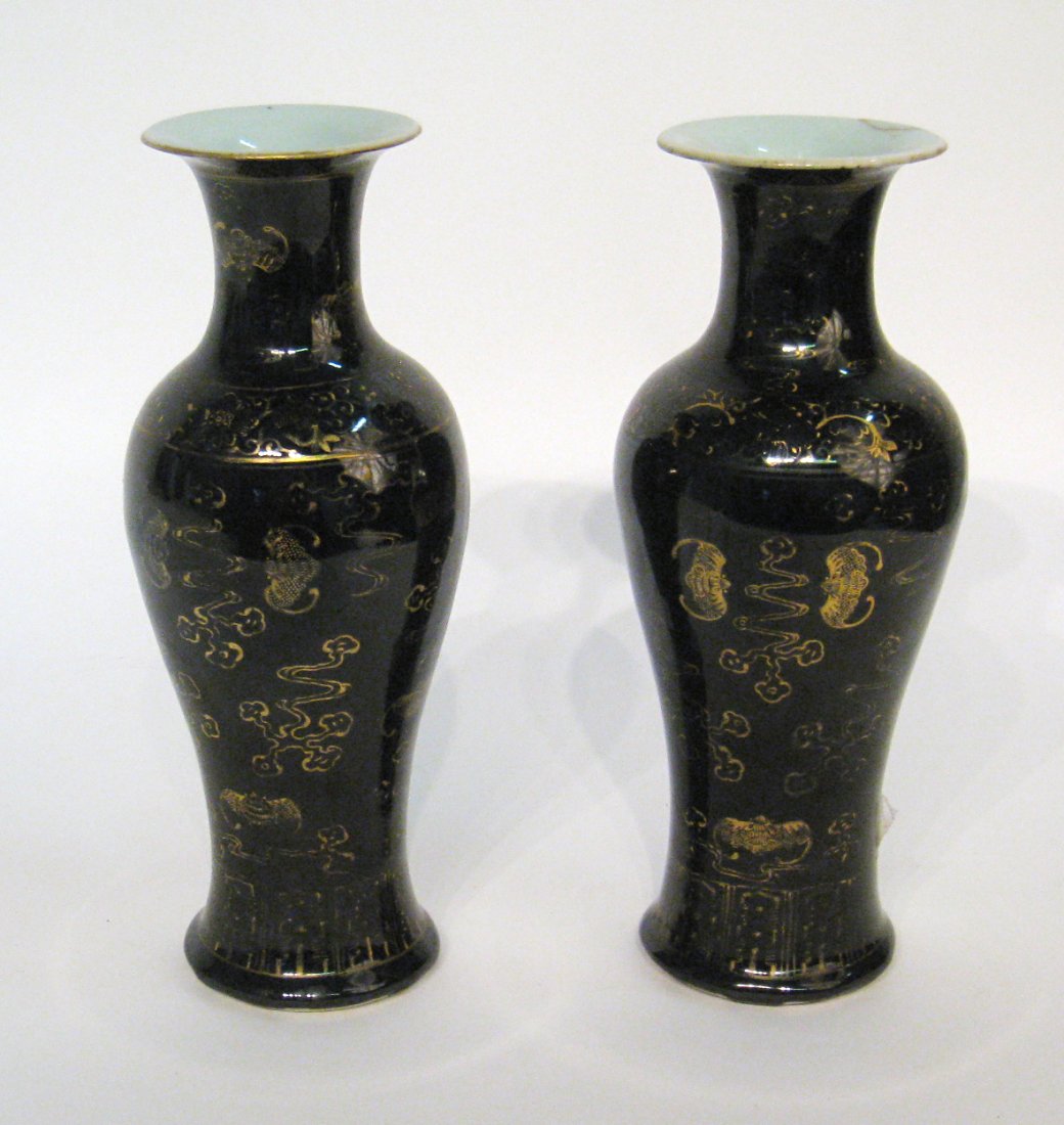 Pair Chinese Vases: A pair of 10" Chinese black glazed porcelain baluster vases with gold baluster images of bats and marked with the Qianlong mark on the bottom. One with repaired lip of the trumpet top. Shipping: We ar