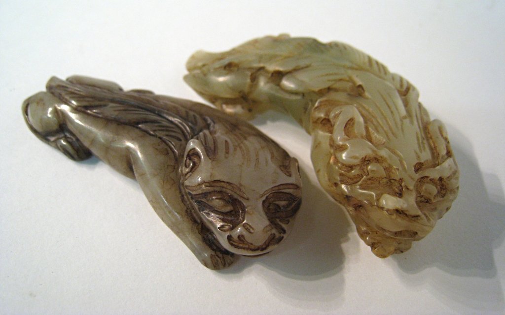 Two Antique Chinese Jade Carved Foo Dogs: Each one about 2 1/5", and running in a curve. Shipping: We are able to pack and ship this item to an address in the United States for $25.00 via USPS Priority Mail. Tracking information will be sent 
