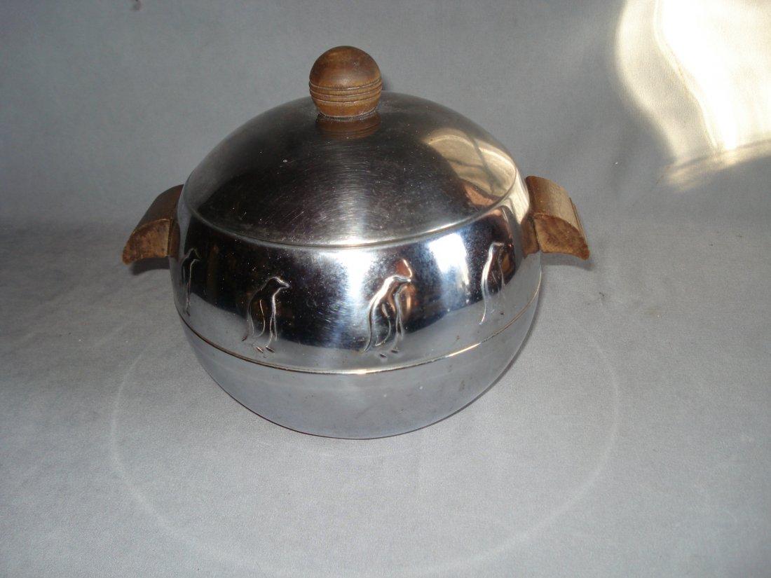 Penguin Ice Bucket: A art deco vintage chrome plated spherical form ice bucket with wood handles and lid finial ringed with penguins, stamped "West Bend Penguin hot and cold server". About 10" X 8". Shipping: We are able