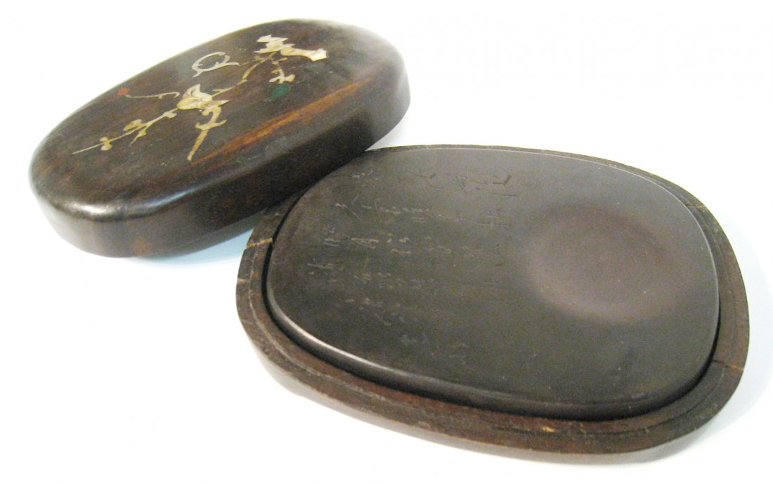 Duan Inkstone: An ink stone is traditionally a stone mortar for the grinding of ink. Ink stones from, this example, believed to be of the Duan culture is carved with calligraphic and comes in a fitted hardwood box w