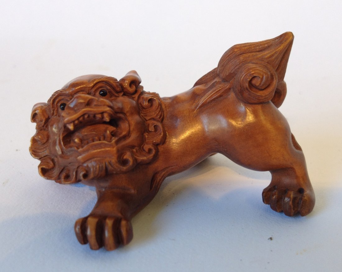 Carved Boxwood Japanese Foo Dog Netsuke: A Japanese carved Netsuke, 52 mm in boxwood of a Foo Dog. Shipping: We are able to pack and ship this item to an address in the United States for $15.00 via USPS Priority Mail. Tracking information wi