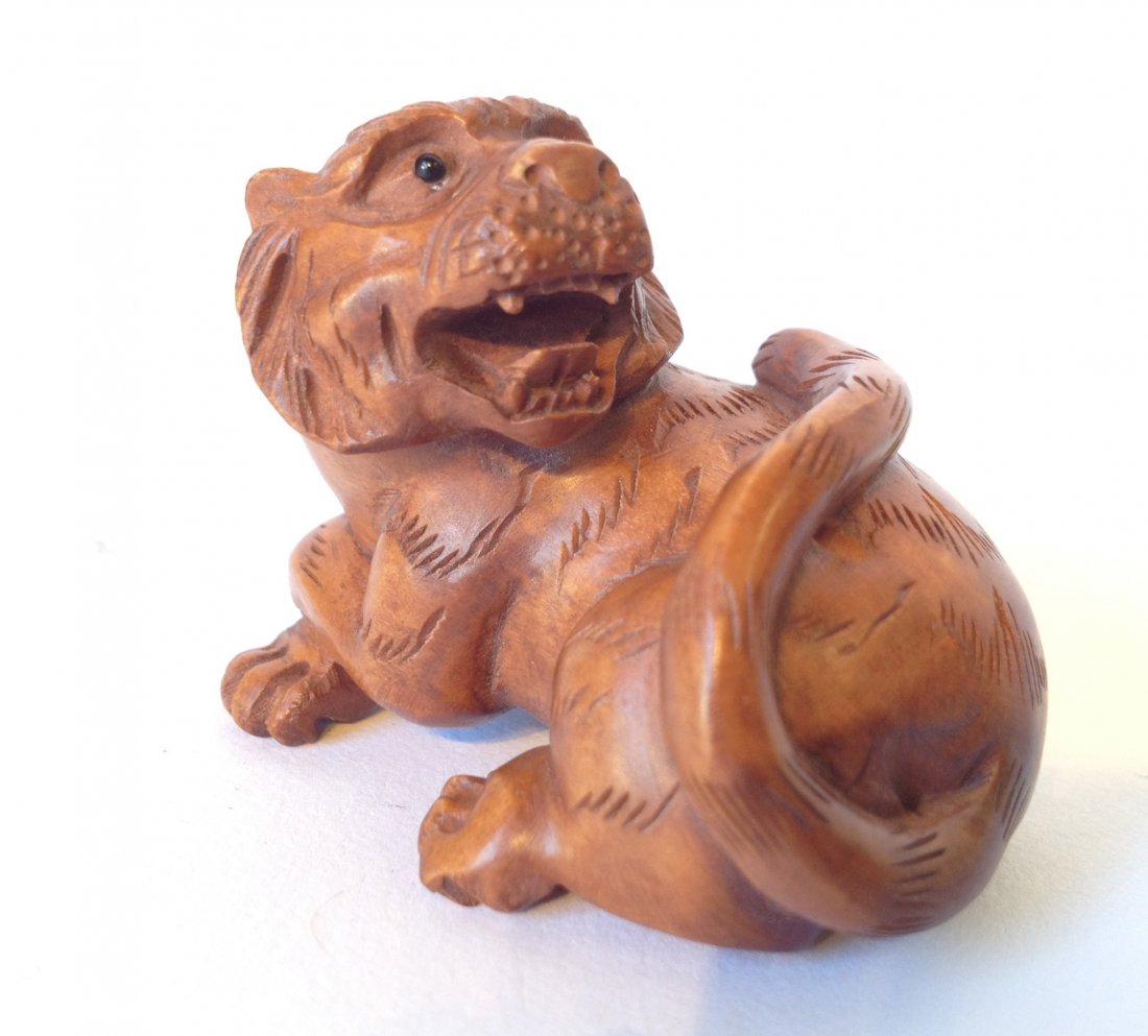 Carved Boxwood Japanese Tiger Netsuke: 45 mm long, in boxwood of a tiger with his paws crossed. Shipping: We are able to pack and ship this item to an address in the United States for $15.00 via USPS Priority Mail. Tracking information wil