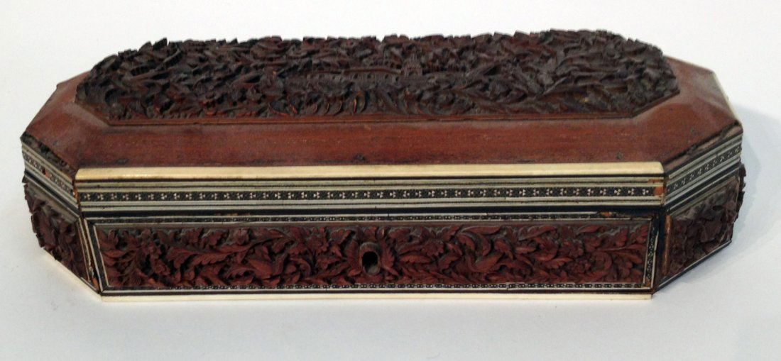 Carved And Inlay Box: A 21" long rectangular lidded box with a carved bas relief top and bordered by inlay of ebony and ivory or bone. Losses of inlay at the bottom rear area. Shipping: We are unable to ship this item. Ple