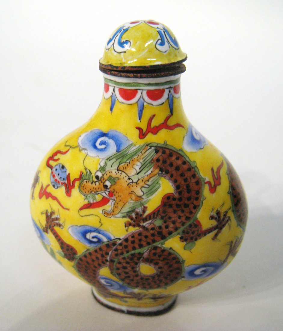 Yellow Enamel Snuff Bottle: Yellow enamel on copper snuff bottle, decorated with dragon pattern. Four character Qianlong mark on base. 2 1/2" Shipping: We are able to pack and ship this item to an address in the United States fo