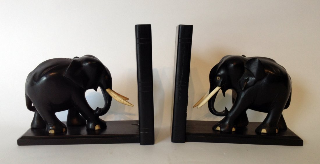 Elephant Bookend: Book ends. Ebony carved elephants with ivory or bone inserted tusks. Shipping: We are able to pack and ship this item to an address in the United States for $50.00 via USPS Priority Mail or via FedEx