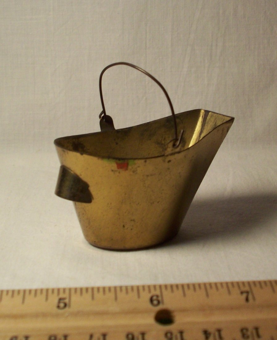 Bellows And Coal Bucket: A brass coal bucket and bellows for fireplace. Shipping: We are able to pack and ship this item to an address in the United States for $25.00 via USPS Priority Mail. Tracking information will be sent