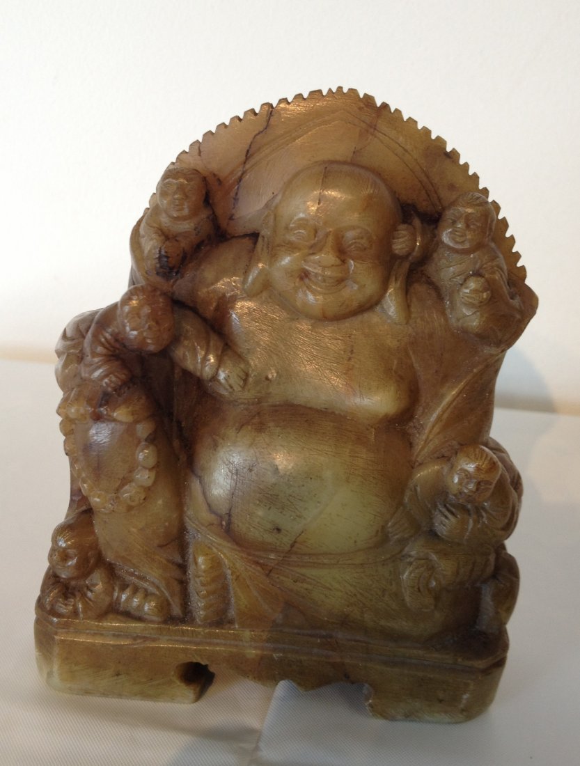 Soapstone Buddha: A laughing seated Buddha in brown soapstone, 4 1/4" tall. Shipping: We are able to pack and ship this item to an address in the United States for $25.00 via USPS Priority Mail. Tracking information wi