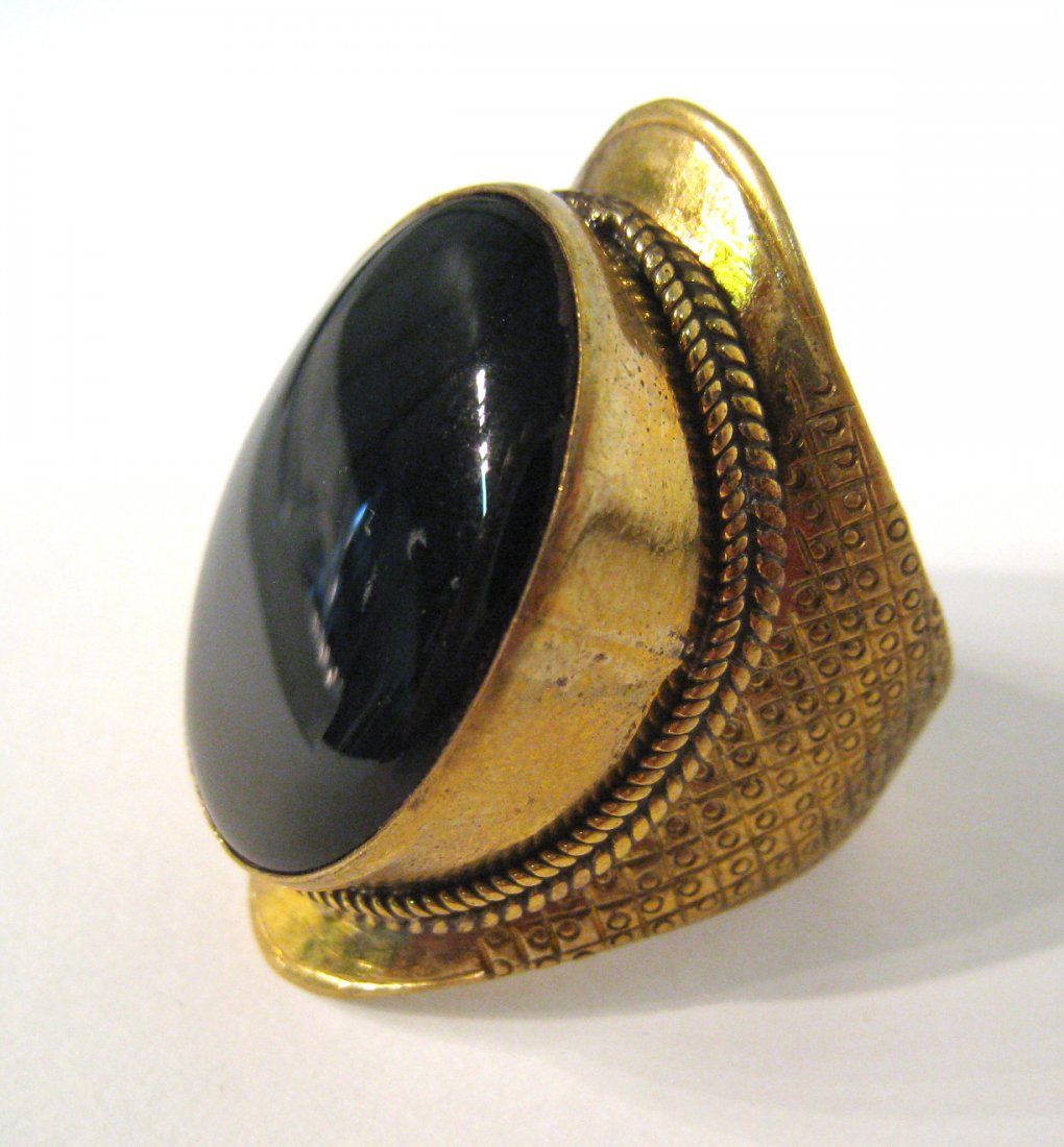 Black Cabochon Ring: A man's ring of possible Nepalese or Tibetan origin. Brass setting. Shipping: We are able to pack and ship this item to an address in the United States for $15.00 via USPS Priority Mail. Tracking info