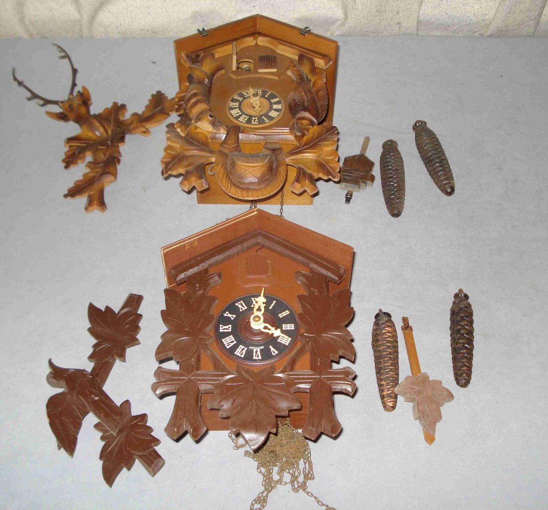 Two Cuckoo Clocks: Each with hand carved cases, pendulums, crests and their two weights. Shipping: We are unable to ship this item. Please contact our local UPS Store, store1152@theupsstore.com, or the Packaging Store, 
