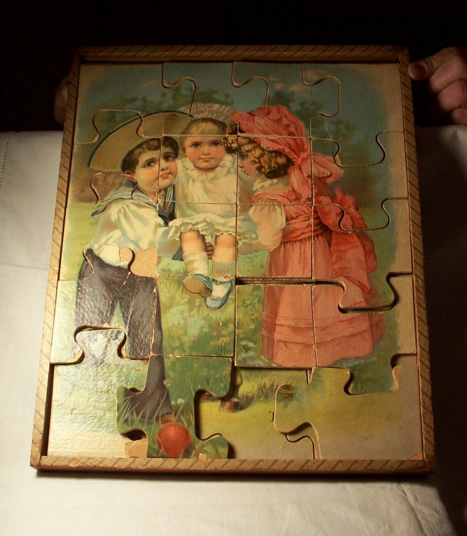 Antique Children's Puzzles: A stacked puzzle within a fitted box, possibly missing pieces but an old-time lithograph. Shipping: We are able to pack and ship this item to an address in the United States for $25.00 via USPS Priori