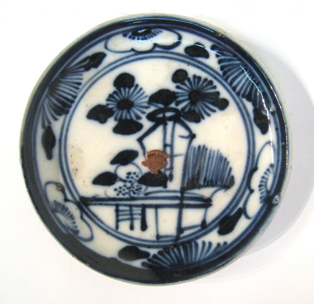 Chinese Flo Blue Saucer: An antique blue and white glazed saucer, 5 1/4" in diameter featuring the export stamp and with the footed bottom. Shipping: We are able to pack and ship this item to an address in the United States f