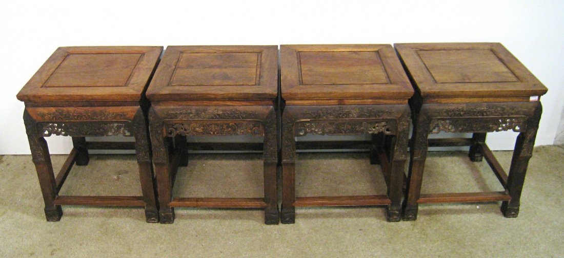 Set Of Four Huanghuali Stools: A set of four carved stool chairs, each with squared legs, carved leafy feet, and bas relief and pierced craved skirts on all fur sides. Shipping: We are unable to ship this item. Please contact our l