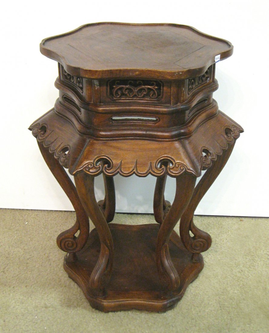 Chinese Huanghuali Vase Stand: A hardwood vase stand, 18" X 28 1/2", featuring five carbroile shaped legs and a lower base, scalloped skirts and hexagonal shaped top. 19th century. Shipping: We are unable to ship this item. Please 