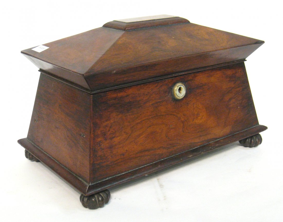 Tea Caddy: A mid 19th century English tea caddy in rosewood veneer with fitted nacre escutcheon opening to a pair of well fit tea canisters aside a receptacle for mixing. 14" X 9" Shipping: We are able to pack a