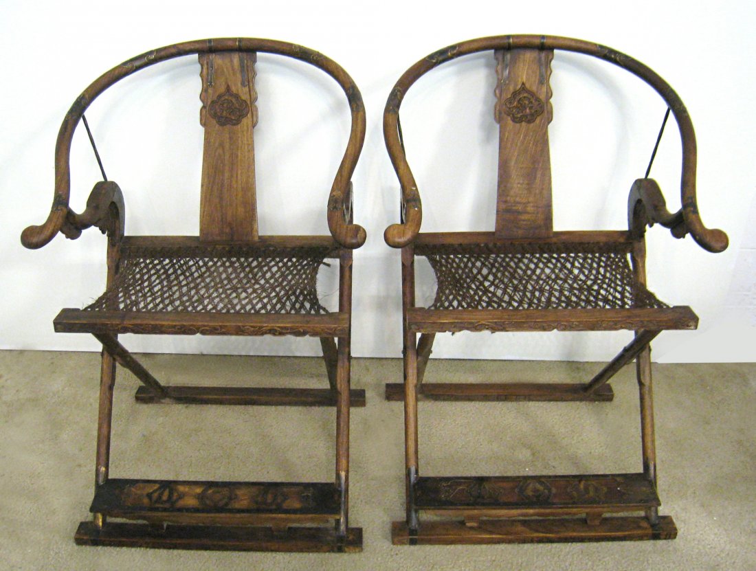 Pair Chinese Of Huanghuali Folding Chairs: A pair of 19th century 41' folding travel or outdoor chairs with cord seating bottoms and the frame fit with brass accouterments. Shipping: We are unable to ship this item. Please contact our local UP