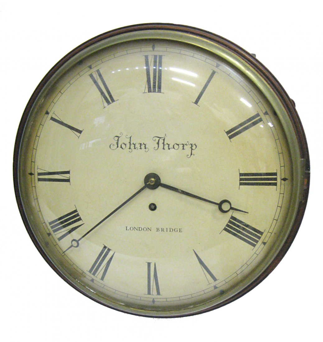 English Pub Clock By John Thorpe: A fusee spring driven English 19th century pub timepiece in a mahogany case with convex white dial lens and cast a brass bezel. Anchor recoil escapement, 12". This timepiece is from the collection of 