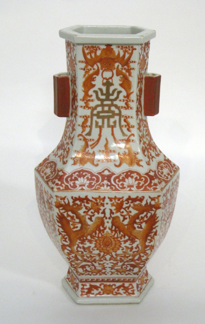 Chinese Porcelain Vase: A six-sided vase with red iron oxide glaze featuring intertwined bats, vines, flowers and mythical creatures. Mark on bottom. Shipping: We are able to pack and ship this item to an address in the Unit