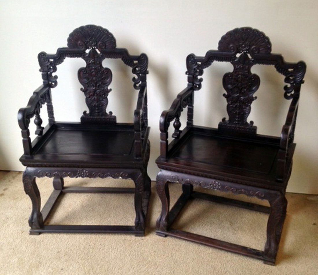 Chinese Royal Zitan Chairs: A elaborately carved pair of Chinese royal style chairs featuring elaborately carved back splats and legs. 45". Shipping: We are unable to ship this item. Please contact our local UPS Store, store1152