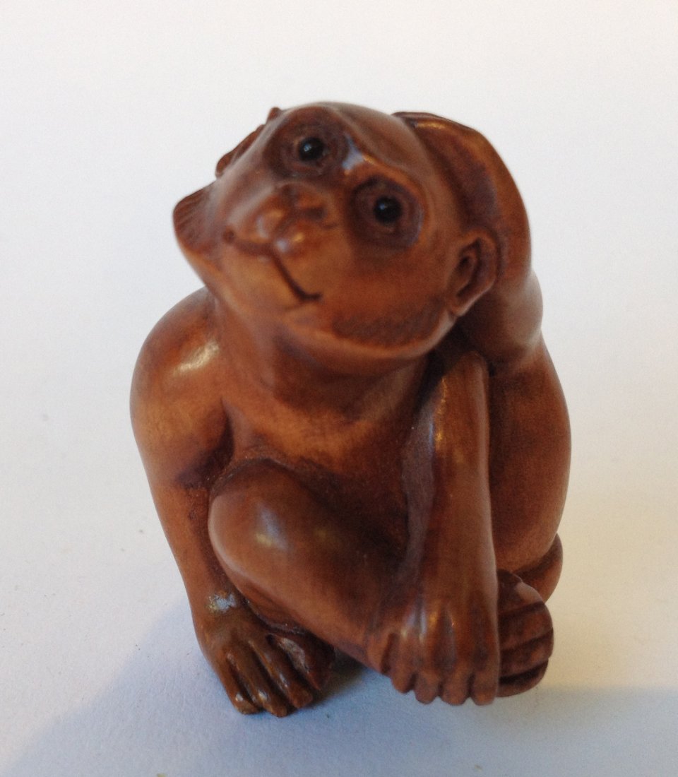 Carved Boxwood Japanese Netsuke: A 42 mm carved monkey in the seated position. Shipping: We are able to pack and ship this item to an address in the United States for $15.00 via USPS Priority Mail. Tracking information will be sent t
