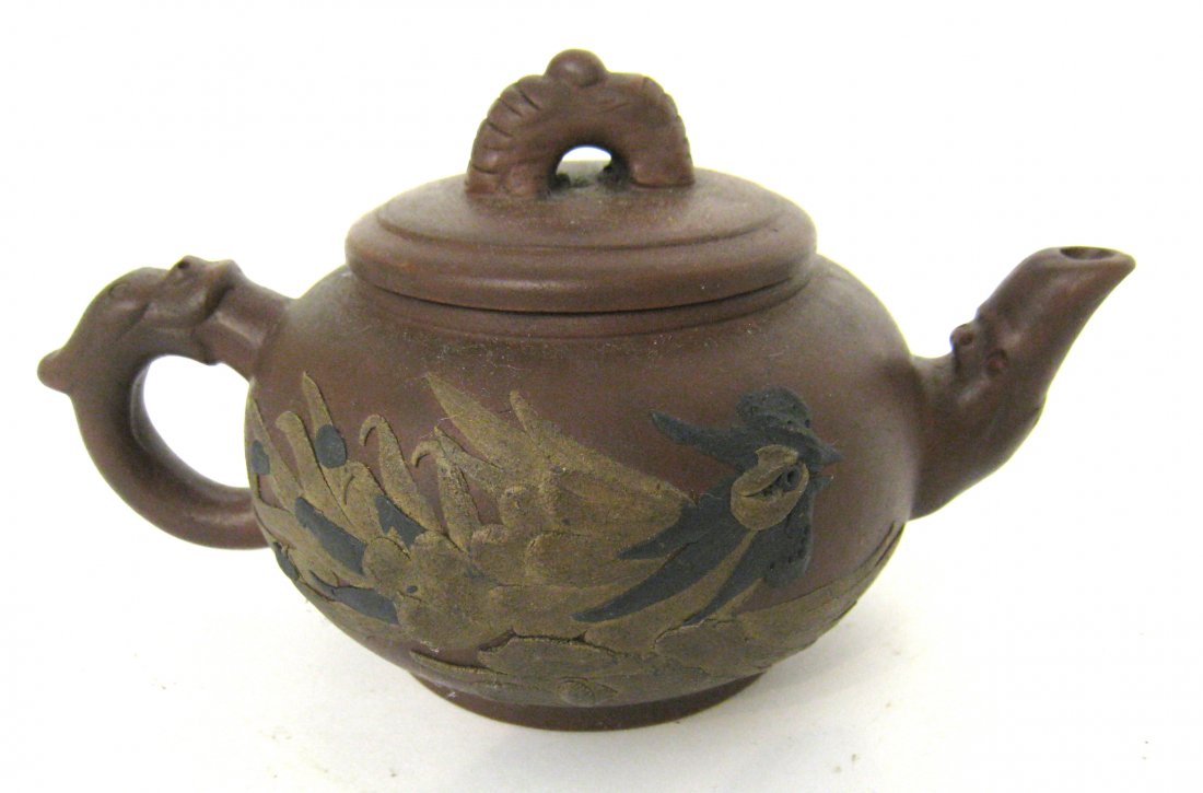 Chinese Yixing Teapot: A stone ware like ceramic Chinese teapot decorated with a gold colored dragon. Shipping: We are able to pack and ship this item to an address in the United States for $30.00 via USPS Priority Mail. Tr