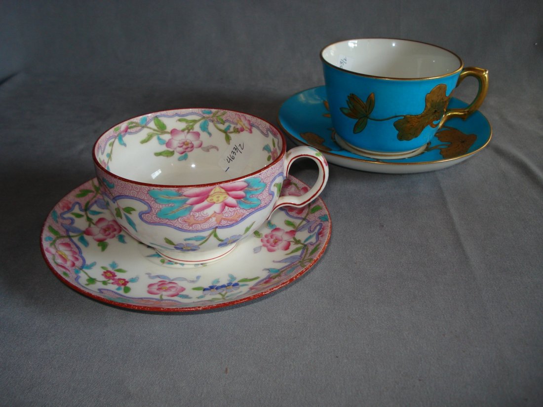 Two Coffee Or Tea Cups By Minton: Larger cups, with one in the Art Nouveau style with the Minton mark and "Daniells, Wigmore St., London"; the other in pinks and blues, etc. Shipping: We are able to pack and ship this item to an addre