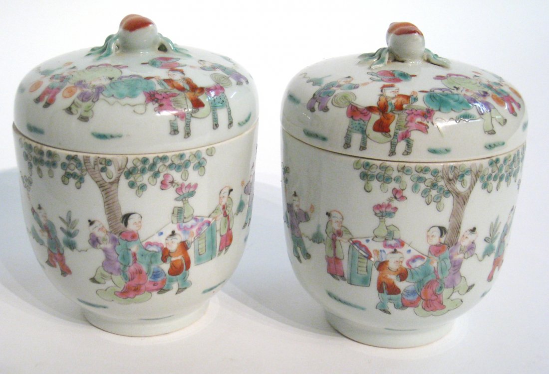 Pair Of Chinese Lidded Jars: Two Chinese porcelain jars with fitted lids and fine Famille Rose decoration, possibly garnitures or for ginger storage. Maker's mark at the bottom. Each 6 1/2". Shipping: We are able to pack and ship