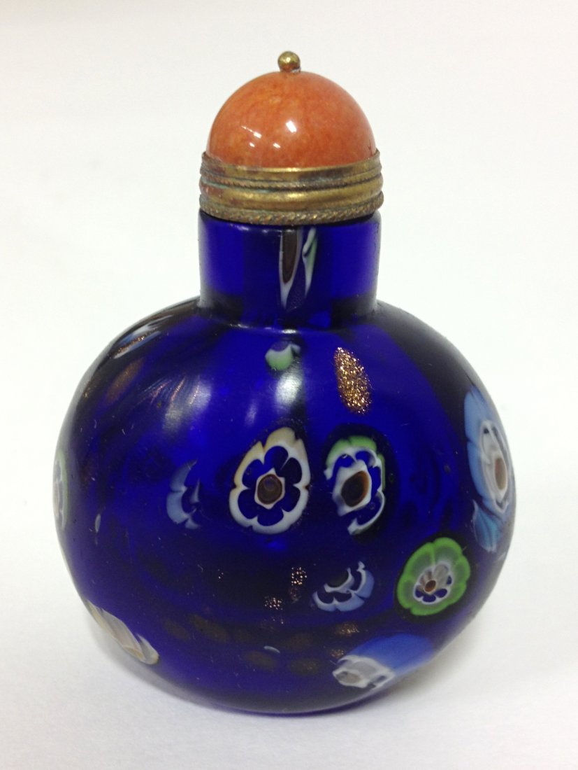 Chinese Snuff Bottle: Blue glass snuff bottle suffused with round glass insets. 3" Shipping: We are able to pack and ship this item to an address in the United States for $15.00 via USPS Priority Mail. Tracking information