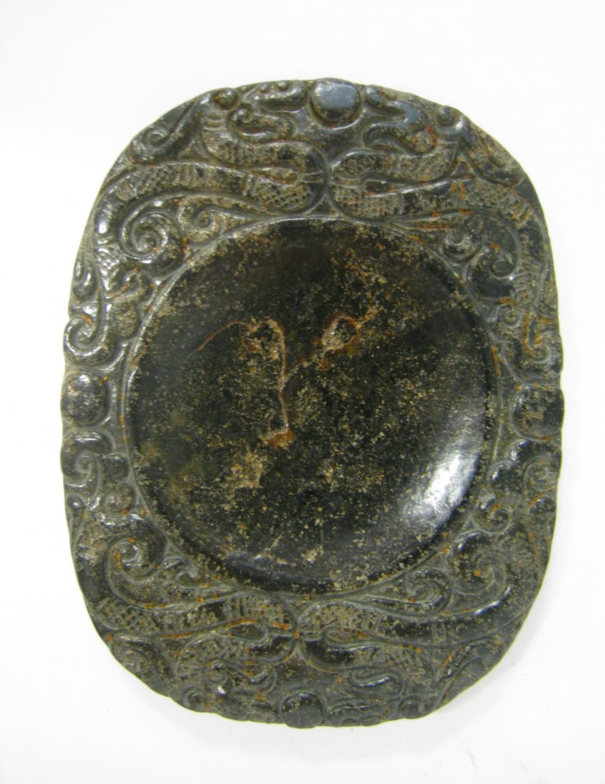 Chinese Jade Inkstone: A 3 1/8" oval shaped inkstone whose bowl is surrounded by carved-in patterns. Shipping: We are able to pack and ship this item to an address in the United States for $25.00 via USPS Priority Mail. Tra
