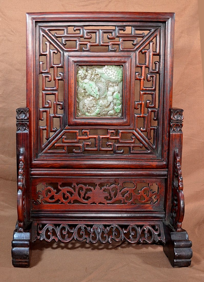 Rosewood Screen with Jadeite Plaque: A Chinese carved wood and jadeite table screen, 18th century. About 19 3/4" tall. Shipping: We are able to pack and ship this item to an address in the United States for $50.00 via USPS Priority Mail 