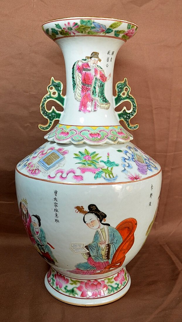 Chinese Daoguang Porcelain Vase: A 19th century porcelain vase with a figure and the Daoguang mark on base. Two dragon hand holders. 17 1/2" tall. Shipping: We are able to pack and ship this item to an address in the United States fo