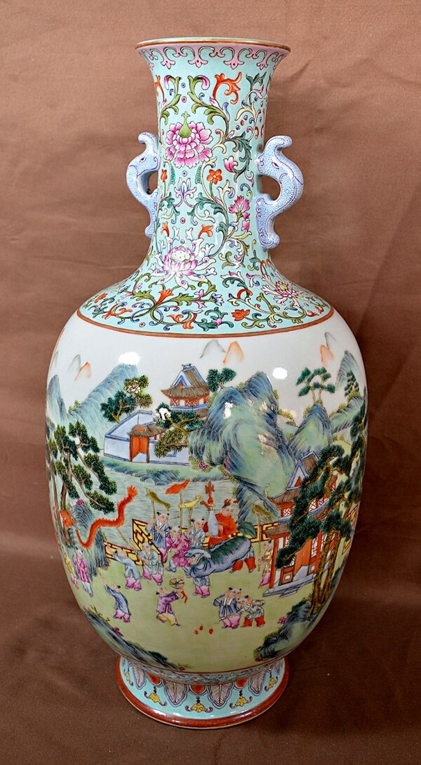 Famille Rose Vase: Porcelain vase, decorated with landscape and carved dragon shaped holder, blue Qianlong mark on base. 17 3/4" Shipping: We are able to pack and ship this item to an address in the United States for $5