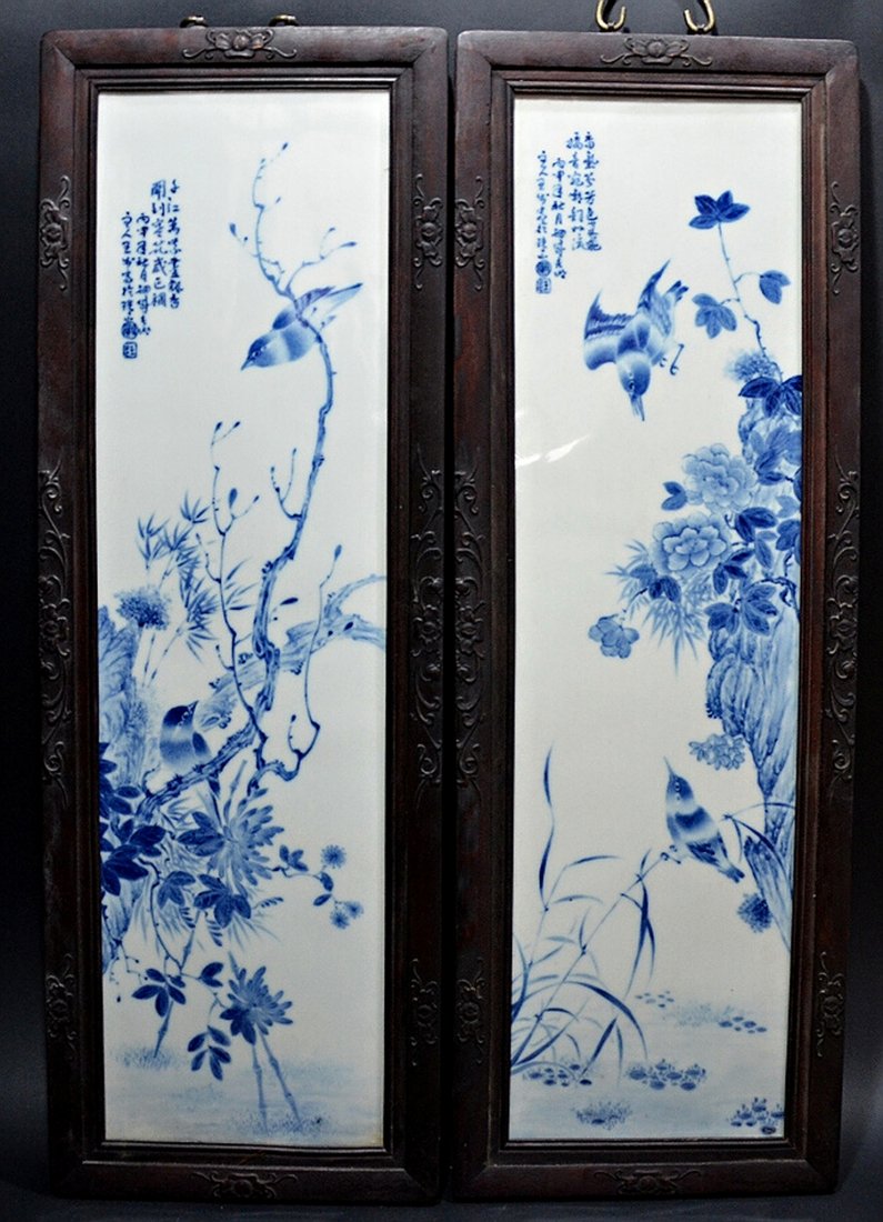 Pair Of Porcelain Plaques: In blue and white, early 20 c. Decorated, signed Wang Bu. Features matching hardwood frames with carved bas relief patterns, possibly rosewood. 32" X 11" each. Shipping: We are unable to ship this ite