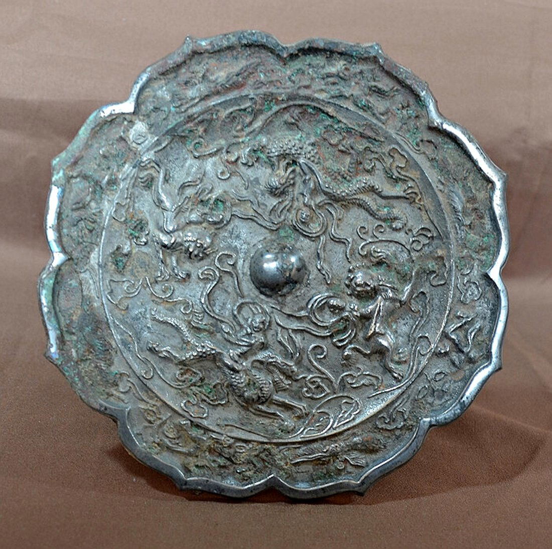Bronze Mirror: Carved bronze mirror in the Tang style. 7 1/2" diameter. Shipping: We are able to pack and ship this item to an address in the United States for $30.00 via USPS Priority Mail. Tracking information wil