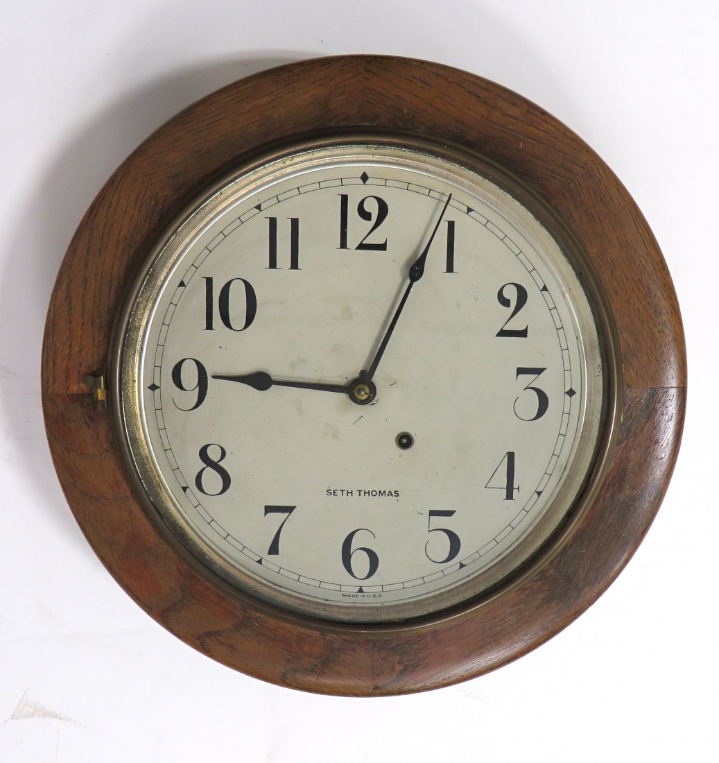 Clock- Seth Thomas Gallery Clock: A 15" solid oak gallery clock with a timepiece movement, lacking pendulum bob. Shipping: We are able to pack and ship this item to an address in the United States for $55.00 via USPS Priority Mail or