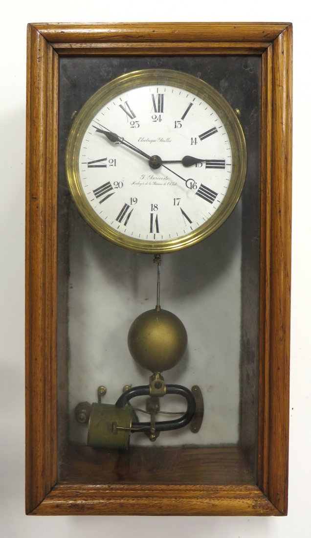 Clock- Brillie Electrique: A late 19th century wall clock , being one of the first battery/electric powered domestic clocks invented. Comes to us without a battery pack, and in pieces, but likely complete. Having a solid oak ca