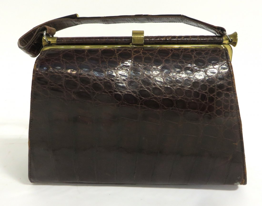 Alligator Style Pocket Book: Handle with a partial break. Shipping: We are able to pack and ship this item to an address in the United States for $30.00 via USPS Priority Mail. Tracking information will be sent to your email addr