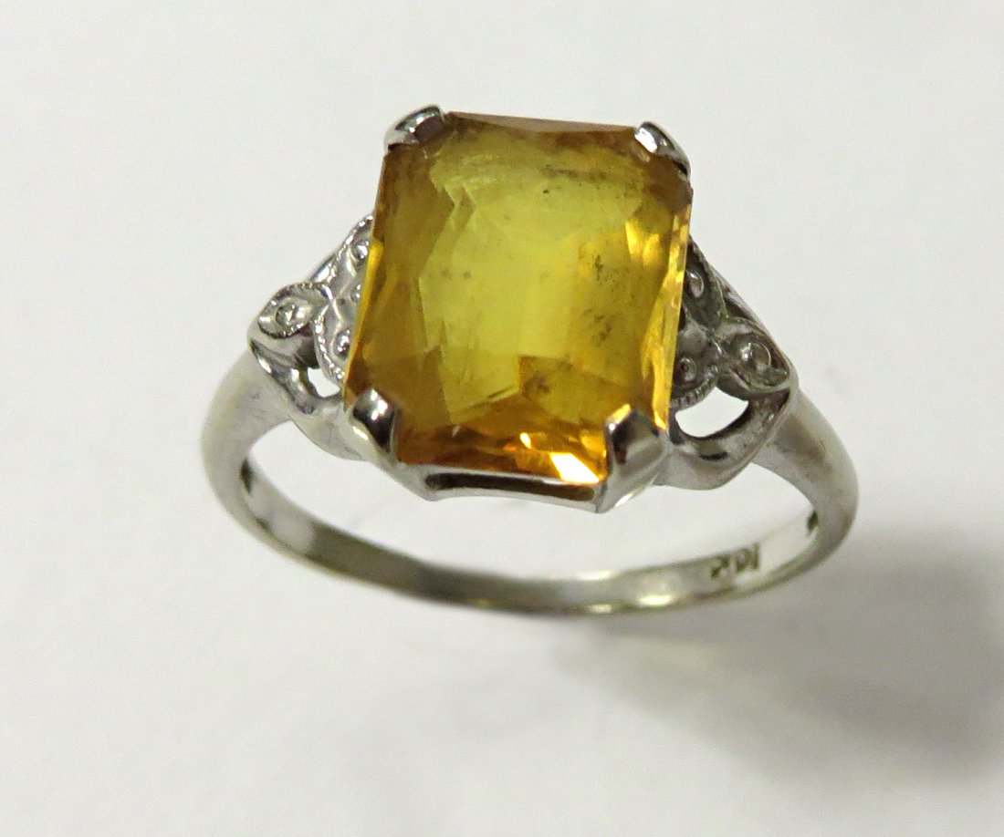 10k Ring: A 10K ring with a solitaire square cut orange/yellow stone. We are not gemlogists. Our representations and opinions of these jewelry items are not guaranteed. The metals have not been tested and the g