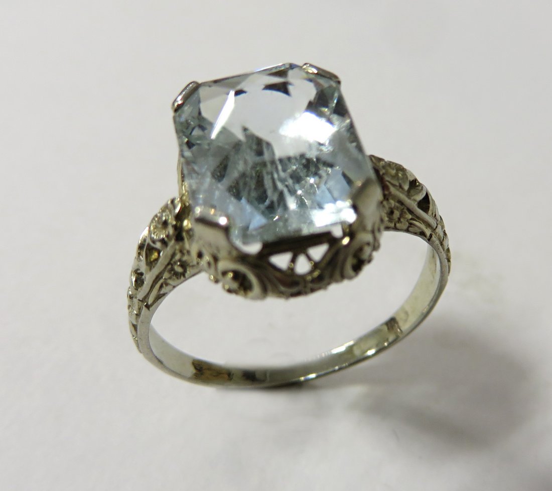 Filagree Ring: A filigree style pin with a central solitaire aquamarine stone of a light blue color. We are not gemlogists. Our representations and opinions of these jewelry items are not guaranteed. The metals have