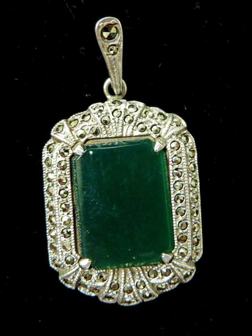 Sterling and Marcasite Pendant: Sterling silver, with a rectangular green stone mounted centrally. Shipping: We are able to pack and ship this item to an address in the United States for $15.00 via USPS Priority Mail. Tracking infor