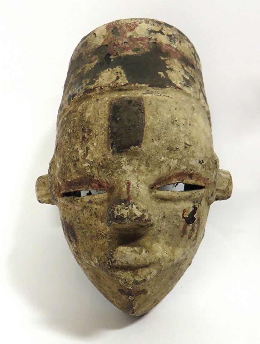 African Mask: A 7 1/2" dance mask with original white and polychrome paint surfaces, believed to be Nigerian. Shipping: We are able to pack and ship this item to an address in the United States for $40.00 via USPS