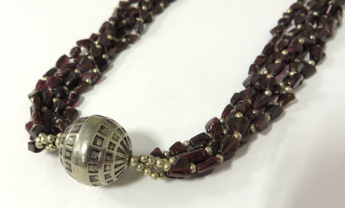Jane Ruddell Design Jewelry: Several strands intertwined, enclosing a silver sphere. Shipping: We are able to pack and ship this item to an address in the United States for $25.00 via USPS Priority Mail. Tracking information will
