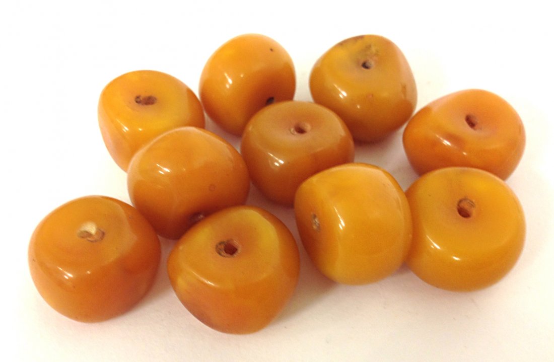 Colored Beads: A set of ten similar peach colored beads, each about 1" and drilled for necklace. Shipping: We are able to pack and ship this item to an address in the United States for $25.00 via USPS Priority Mail.