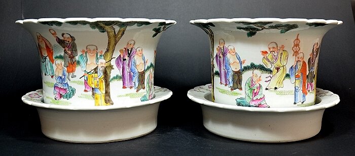 Pair Famille Rose Chinese Flower Pots: With petal rims, and decorated showing Louhan figures within a garden. Bears the 19th C. Qing Daoguang mark on base. 6 1/2" X 10" Shipping: We are able to pack and ship this item to an address in the 